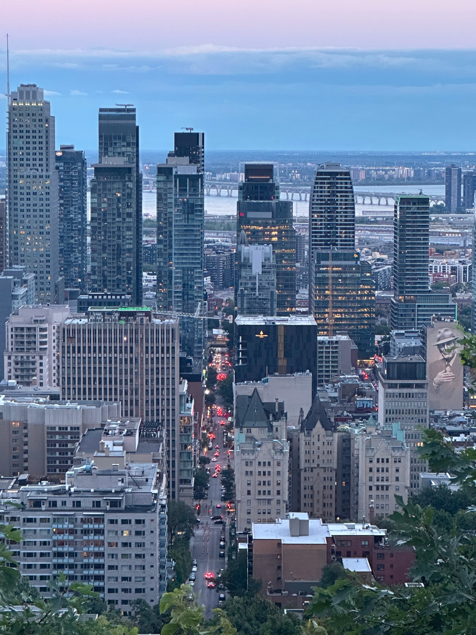 Downtown Montreal and the river viewed from Mount Royal at sunset